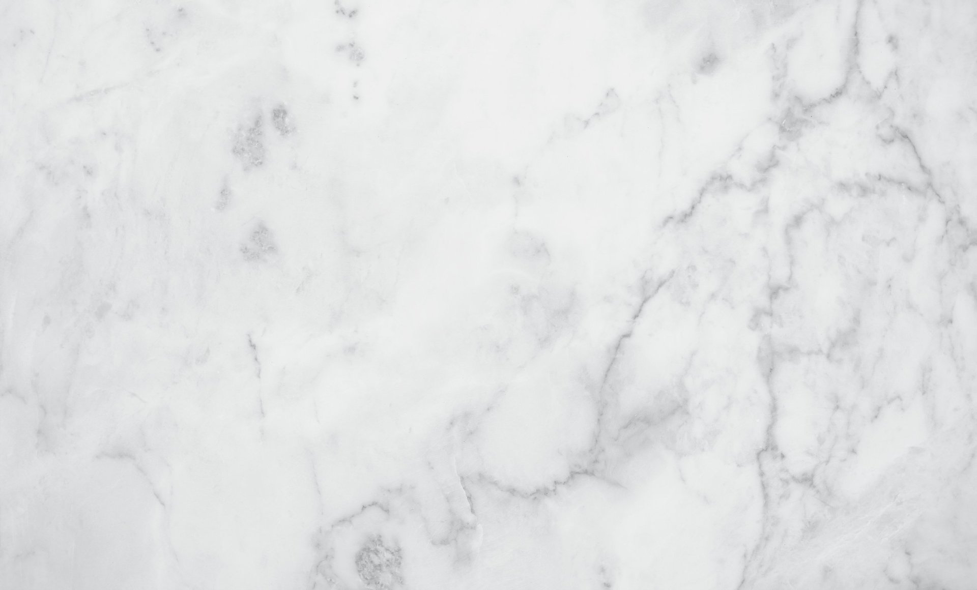 Polished white marble slab surface with glossy reflective finish and grey veining