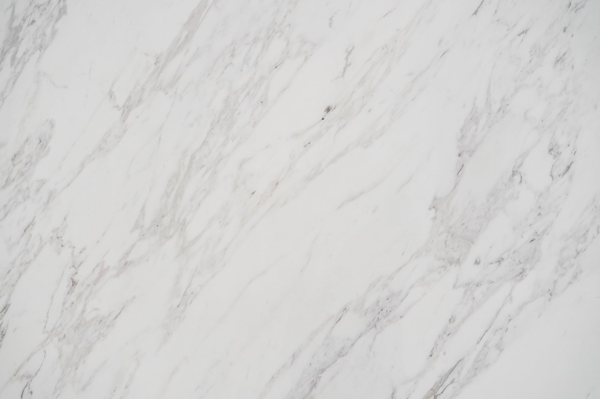 Close-up of polished white marble slab with natural grey veining restored by Manhattan Stone Care
